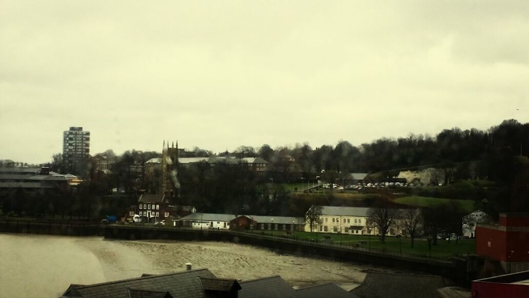 RIVER WITH BUILDINGS IN BACKGROUND