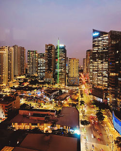 High angle view of illuminated buildings in city at night