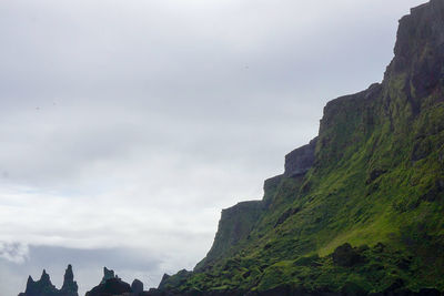 Panoramic view of rocks and sea against sky