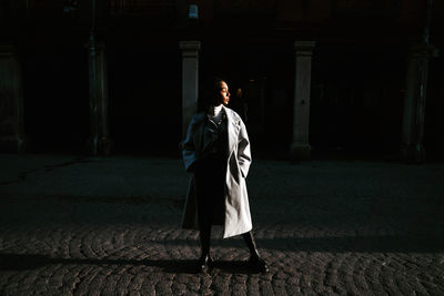 Full length of woman standing against building