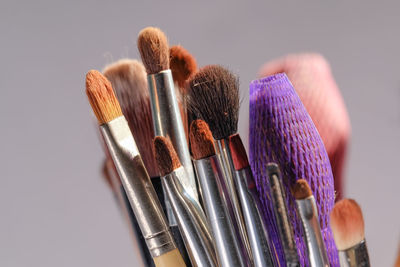 Close-up of multi colored brush against gray background