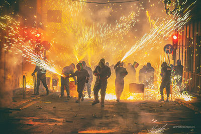 Group of people watching fire crackers at night
