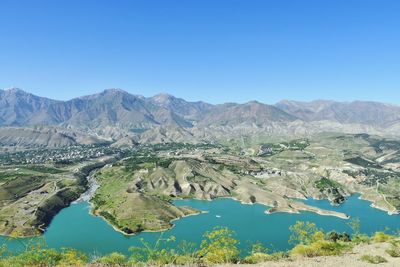 Scenic view of mountains against blue sky