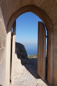 Scenic view of sea against clear blue sky seen through window