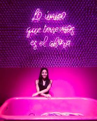 Portrait of a young woman sitting outdoors
