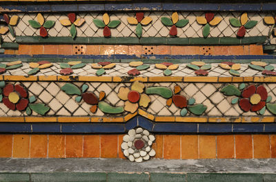 Full frame shot of colorful floral pattern tiles on wall at wat pho
