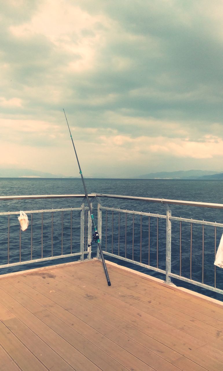 sea, sky, water, cloud - sky, horizon over water, horizon, scenics - nature, beauty in nature, tranquil scene, tranquility, railing, nature, no people, day, rod, idyllic, fishing rod, beach, non-urban scene