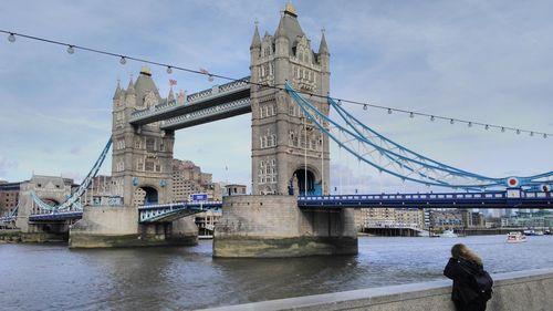 Low angle view of tower bridge over river against sky