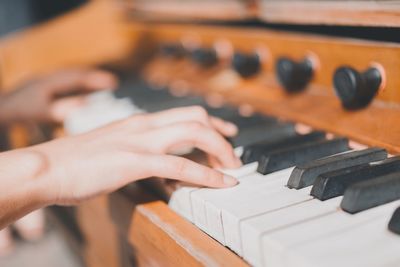 Close-up of hands playing piano