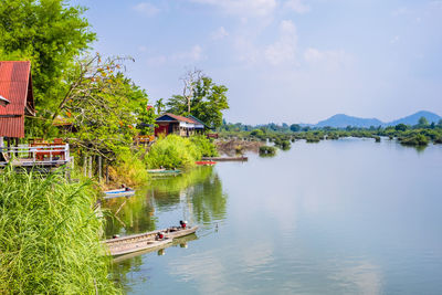 Scenic view of lake by building against sky