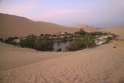 Scenic view of beach against sky during sunset