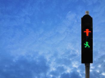 Low angle view of street light against blue sky