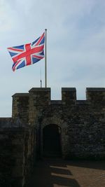 Low angle view of historical building against cloudy sky