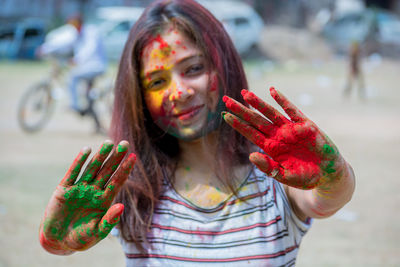 Portrait of young woman eating outdoors