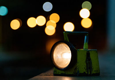 Close-up of illuminated electric light on table