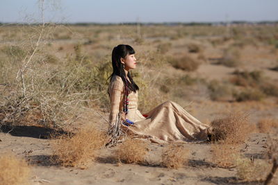 Side view of woman walking on field