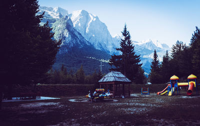 People on snowcapped mountains against sky