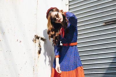 Woman standing against wall