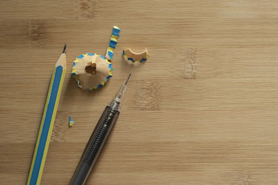 High angle view of colored pencils on wooden table