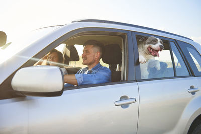 Couple with dog in car