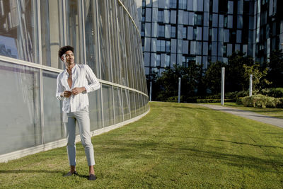 Full length of young man standing on wall