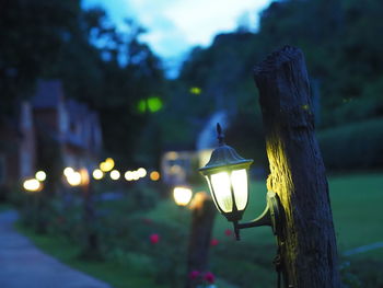 Close-up of illuminated lamp post on street light