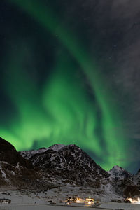 Scenic view of snowcapped mountains against sky at night