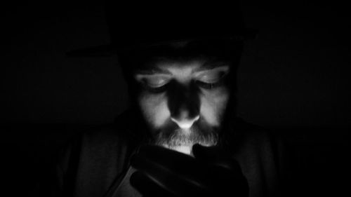 Close-up of hands over black background