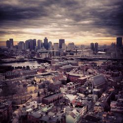 Cityscape against cloudy sky