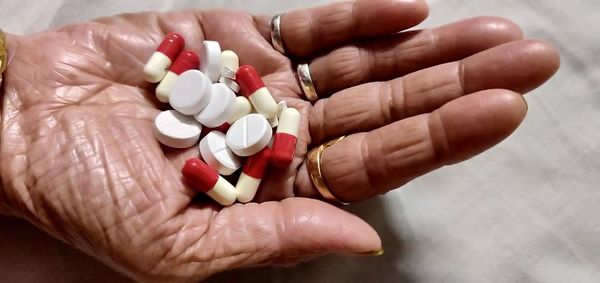 Close-up of person holding pills