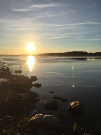 Scenic view of lake against sky at sunset