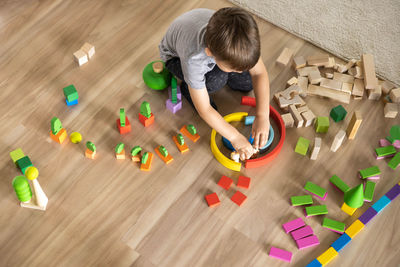 High angle view of boy playing with toys on table