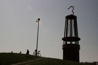 Low angle view of silhouette street light against sky