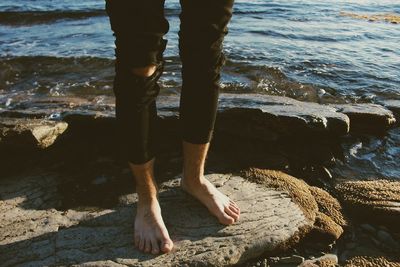 Low section of woman standing in water