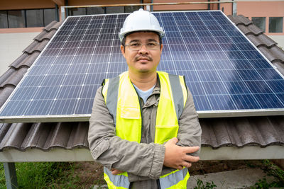 Portrait of man standing on solar panel