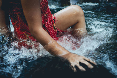 Midsection of woman in river