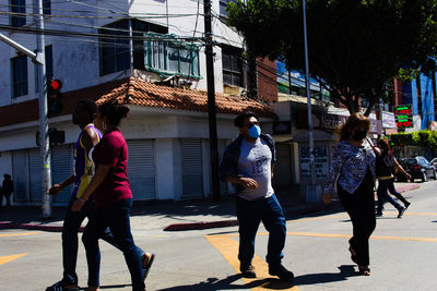 People walking on street in city