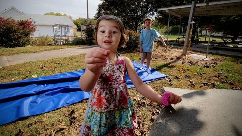 Boy looking at sister gesturing while standing at park