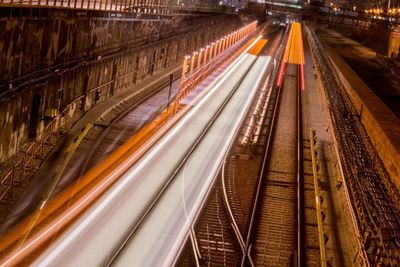 High angle view of light trails on railroad tracks at night