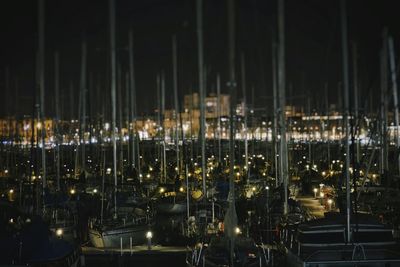 Sailboats in city at night