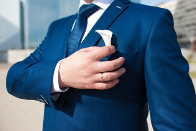 Midsection of man holding umbrella