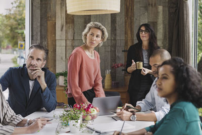 Business people looking away during meeting in portable office truck