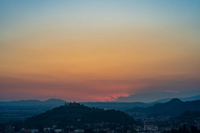 Silhouette buildings against sky during sunset