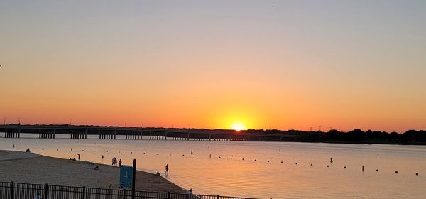 Scenic view of lake against romantic sky at sunset