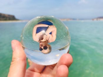 Close-up of person hand holding sea