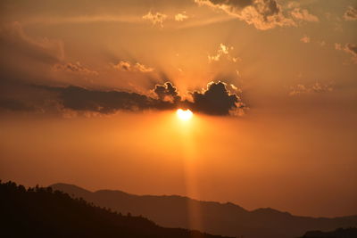 Scenic view of silhouette mountains against sky during sunset