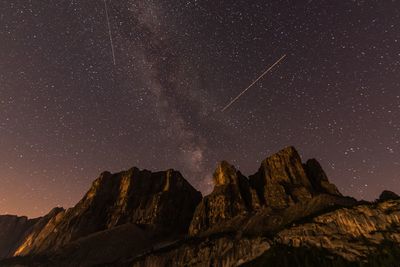 Low angle view of mountain against sky at night