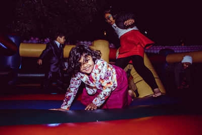 Friends playing on bouncy castle at night