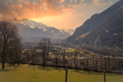 Scenic view of field against sky during sunset