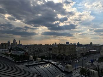 High angle view of buildings against cloudy sky